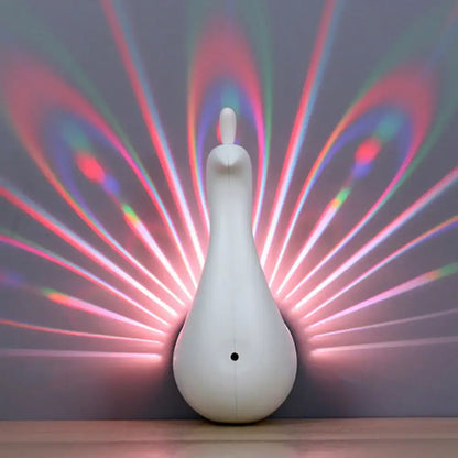 Modern peach peacock wall sconce led light projector casting vibrant rainbow-colored rays on wall for bedroom use