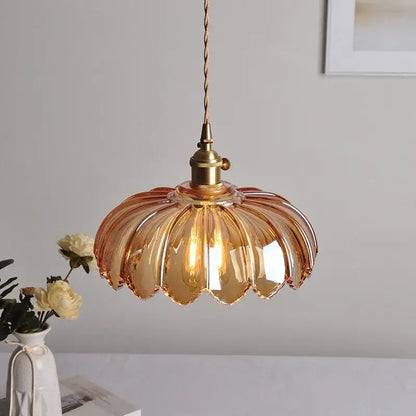 Amber-colored glass led pendant lamp with fluted petal design and brass hardware for dining room lighting