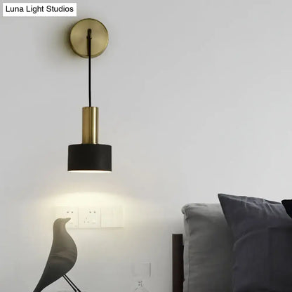 A modern brass and black cylindrical pendant bedside reading light with e14 e26 e27 bulb compatibility and circular mount