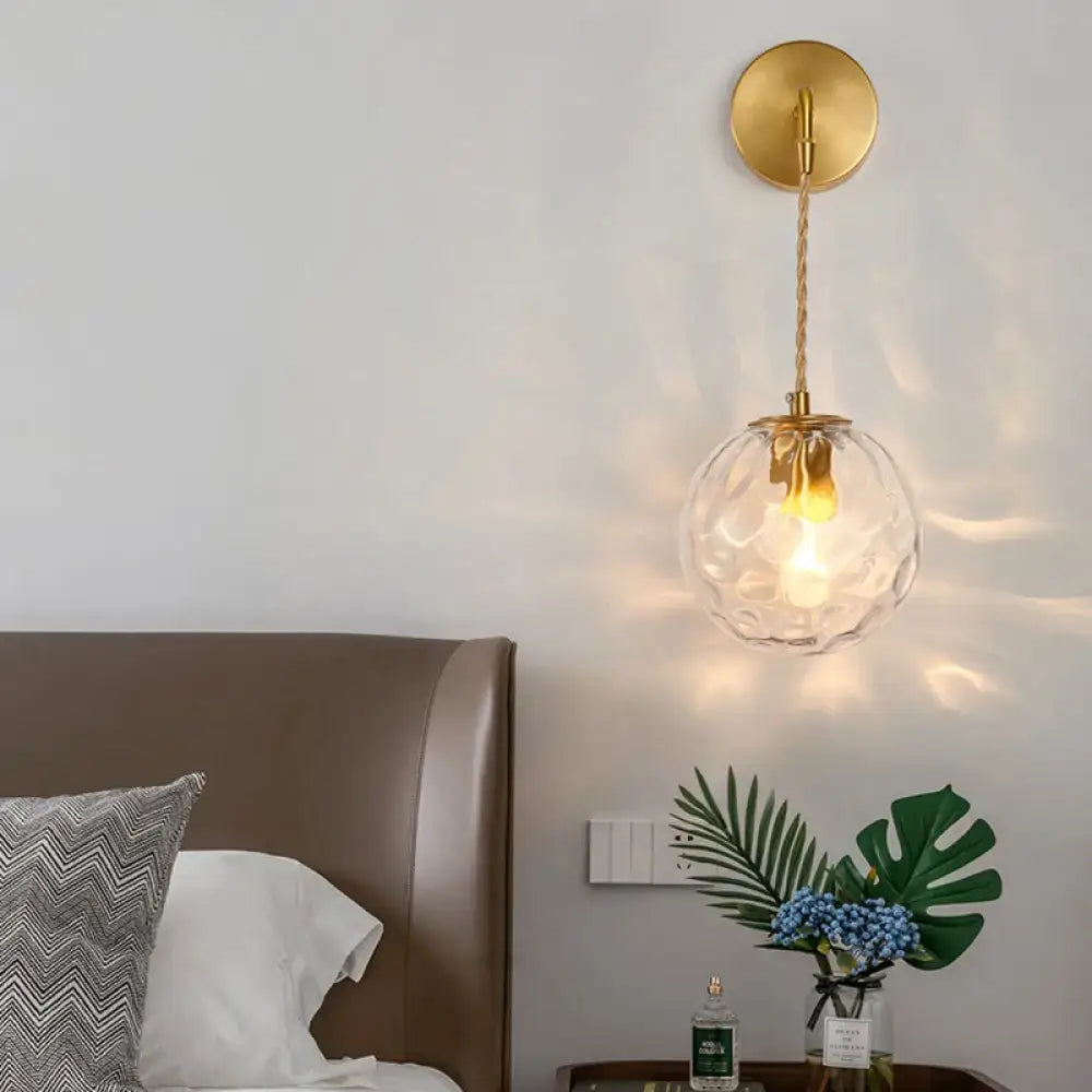 Modern pink and brass bedside reading light with gold-toned wall sconce textured clear glass globe e14 e26 e27