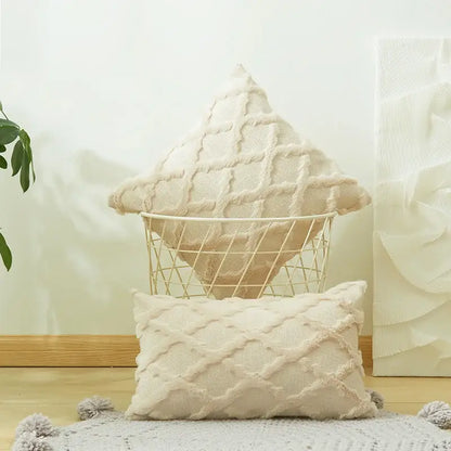 Cream-colored textured knit throw pillows with diamond embroidery cushion cover and tassel trim for living room use