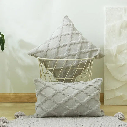 A soft light gray embroidery cushion cover with diamond pattern and tassel trim for modern living room decor