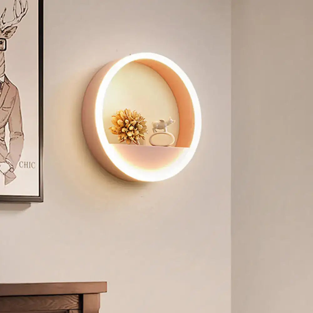 Modern pink and blue iron hoop wall light with warm peach glowing interior and illuminated edge for bedroom storage rack