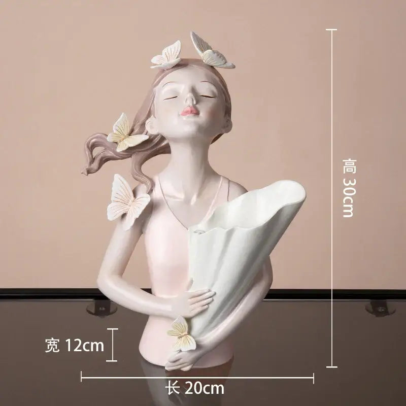 Delicate modern pink butterfly girl resin figure with closed eyes holding a white fan in pastel tones on a gold tray