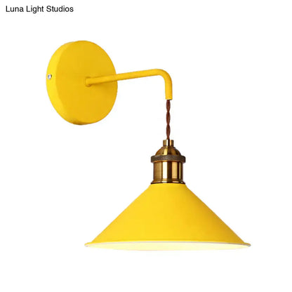 Modern pink conical metal wall sconce with bright yellow industrial style and brass base for gray pink yellow decor