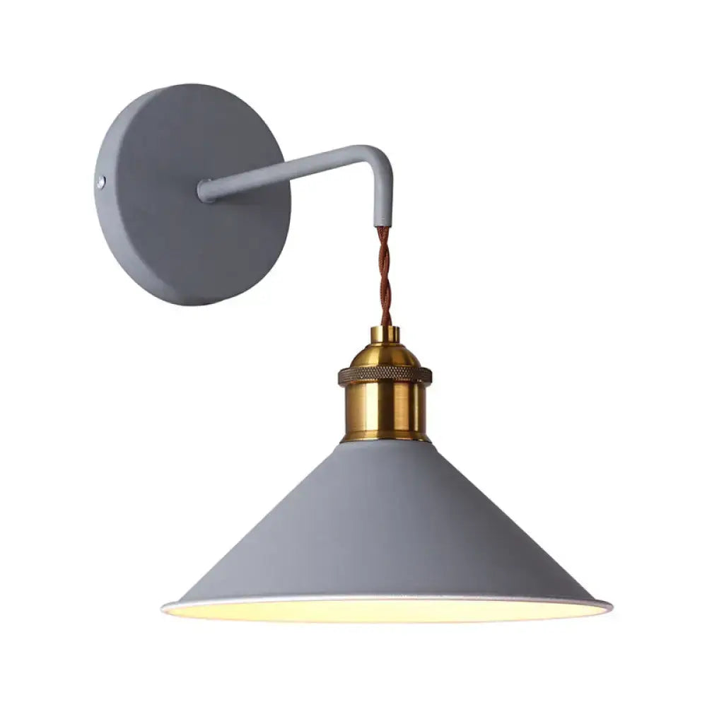 Modern pink conical metal wall sconce with gray pink industrial-style design brass socket and twisted brown cord for hallway lighting