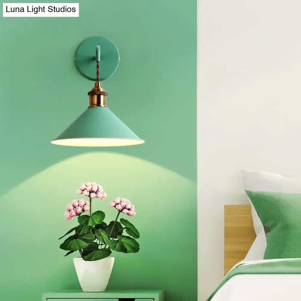 Teal conical metal wall sconce with brass fixture and twisted cord complements modern gray pink yellow decor