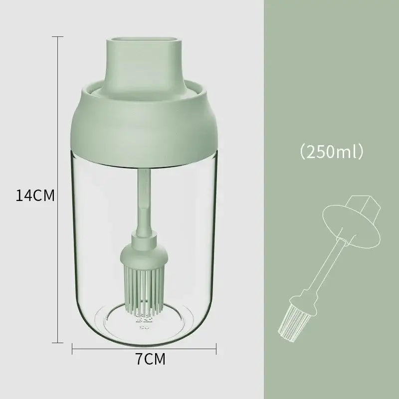 A 250ml transparent glass seasoning bottle with matte sage green lid and internal brush for easy pouring or dipping