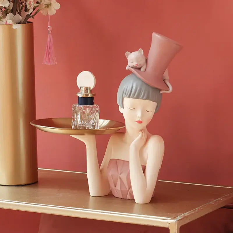 Delicate porcelain sculpture tray featuring a modern pink and gray woman holding a golden tray for home decor by decorbites