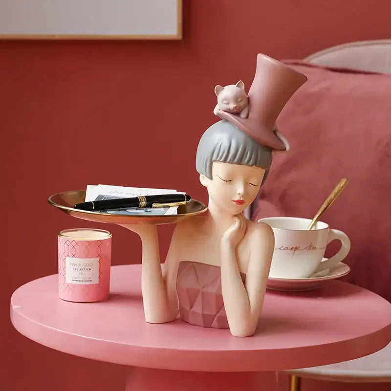 Modern pink and gray ceramic sculpture tray of an elegant woman with a cat hat for home decor by decorbites