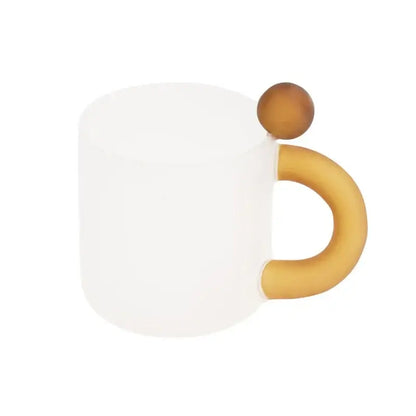 A frosted white ceramic mug with a wooden sphere lid featured in a modern pink and red glass mug set for dining room use