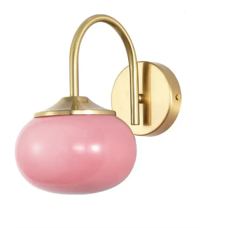 Modern pink frosted glass ball wall lamp with brass-finished metal arm for living room decorbites glass ball lighting
