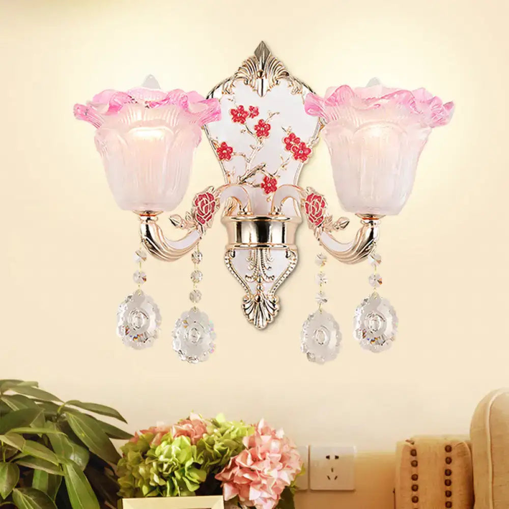 Modern pink and white ruffle glass sconce lamp with crystal droplets and ornate silver metalwork for bedroom wall light