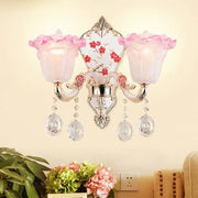 Modern pink and white ruffle glass sconce lamp with crystal droplets and ornate silver metalwork for bedroom wall light