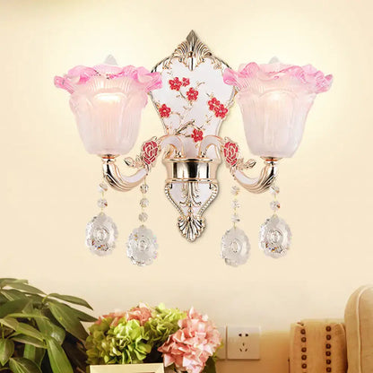 Modern pink and white ruffle glass sconce lamp with crystal droplets and ornate silver metalwork for bedroom wall light