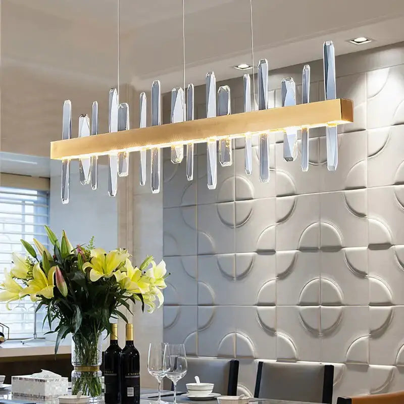 Modern rectangle gold crystal chandelier with clear vertical elements suspended from a sleek horizontal bar