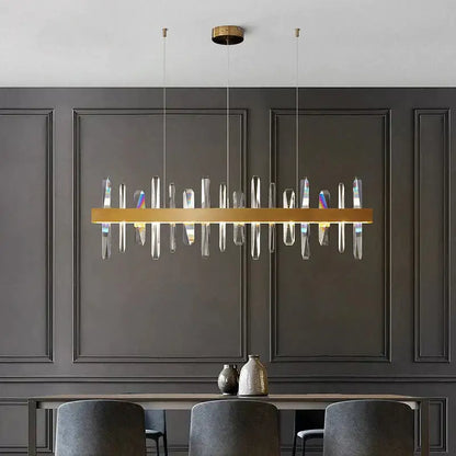 Modern rectangle gold chandelier with clear crystal prisms hanging from ceiling mount by DecorBites™