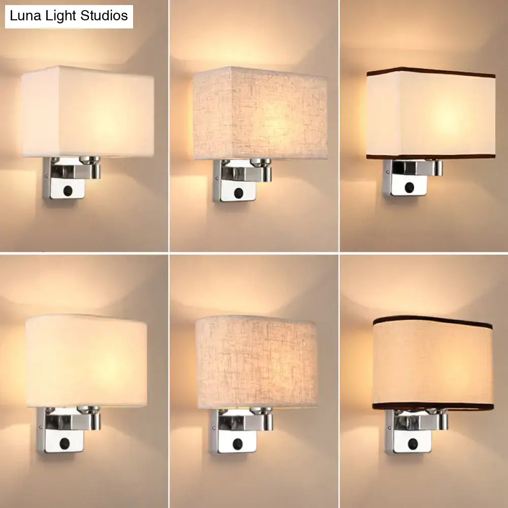 Modern rectangular wall sconce with a sleek chrome fixture and soft, off-white fabric shade featuring subtle texture or trim.
