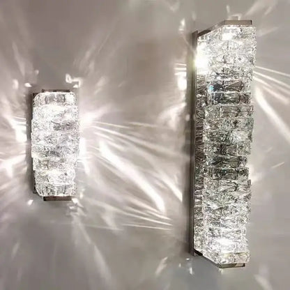 Modern rectangular crystal wall sconce with clear faceted blocks and metallic frame for elegant bedroom decorbites crystal wall lighting
