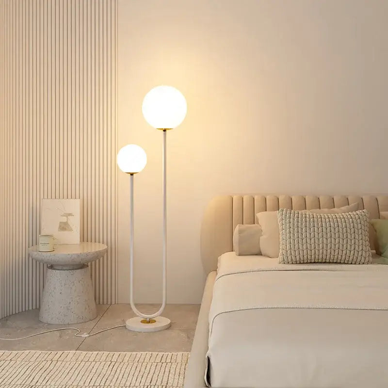 Modern red and white metal floor lamp with dual glass spheres and sleek curved black white metal stand for decorbites black white decor
