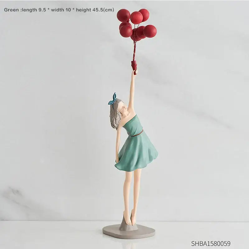 A delicate teal girls resin figurine holding red balloons with a blue bow for modern living room decor