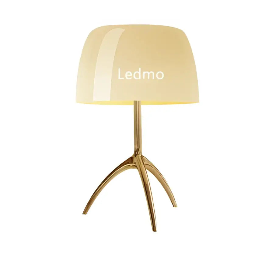 Gold-toned tripod base supporting a cream glass shade table lamp with ledmo branding for bedroom lighting