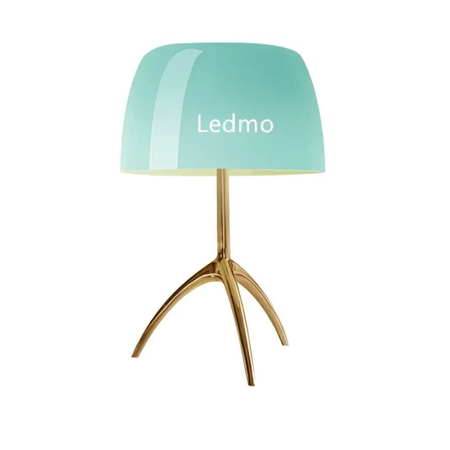 Modern table lamp with a mint green glass shade and gold tripod base featuring the ledmo brand name