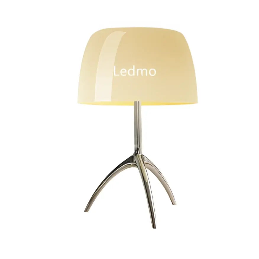 Modern table lamp with cream glossy glass shade and sleek chrome tripod base for bedroom lighting use