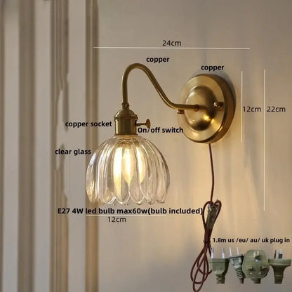 Antique brass-finished copper led wall sconce with clear ribbed glass shade for modern bedroom lighting