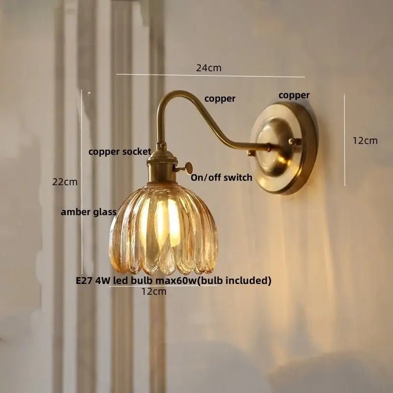 Antique brass-finished wall sconce with ribbed amber glass copper led shade for modern bedroom lighting