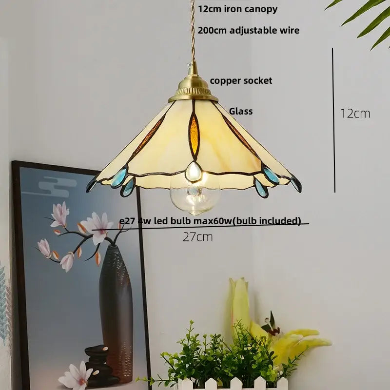 Modern pendant lamp with tiffany-style stained glass shade and brass canopy featuring cream amber and teal accents