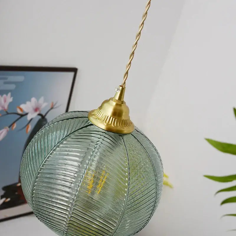 Modern ribbed blue glass led pendant lamp with textured spherical glass and brass finish ideal for dining room lighting