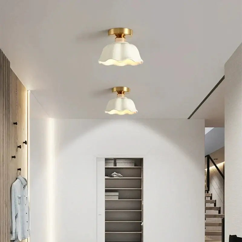 Two elegant white decorbites ceramic glass chandelier pendant lights with ribbed bell-shaped shades and brass fixtures