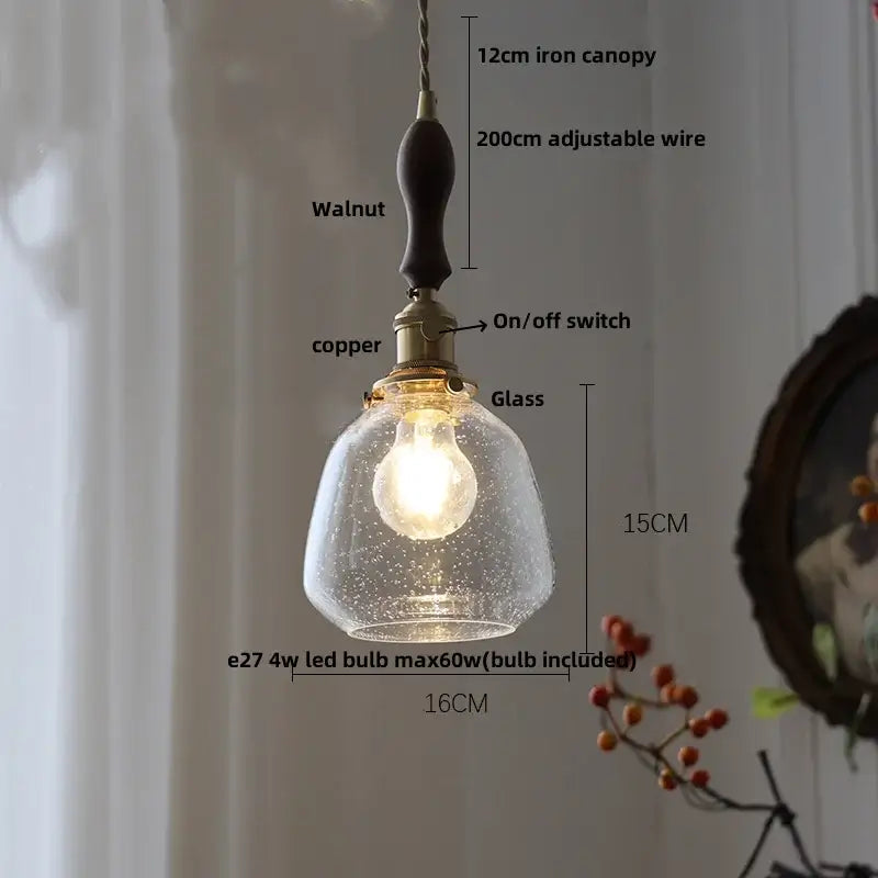 A warm-glowing modern ribbed clear glass pendant light with iron canopy and walnut handle for kitchen decorbites clear glass