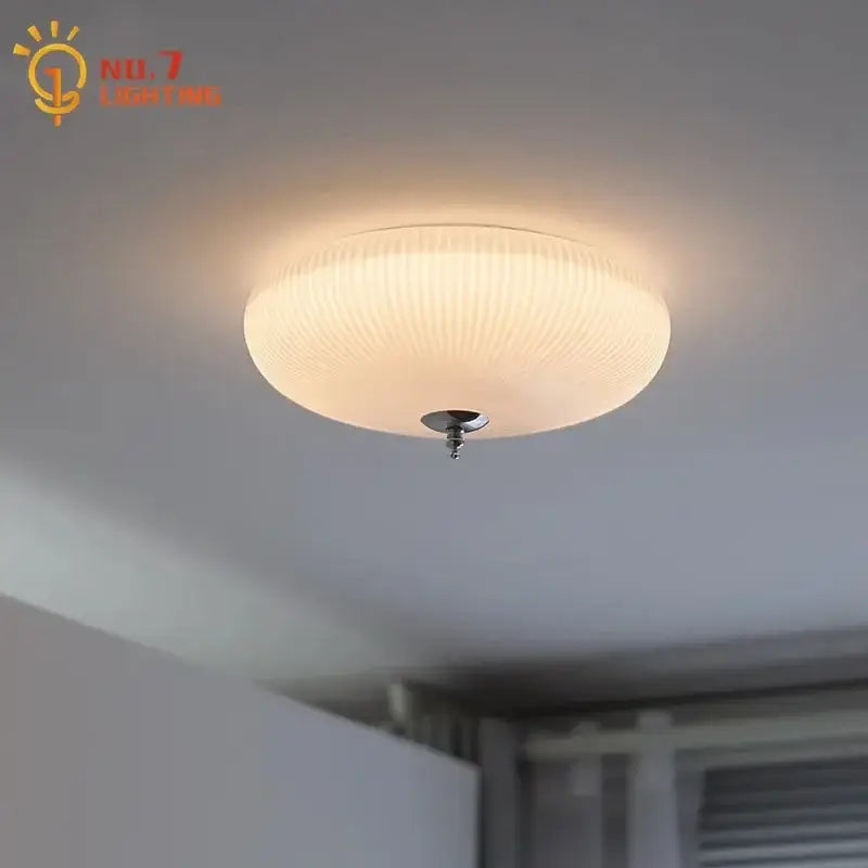 Modern ribbed cream glass round ceiling lights featuring warm-toned ribbed glass and sleek chrome fixture for bedroom decor