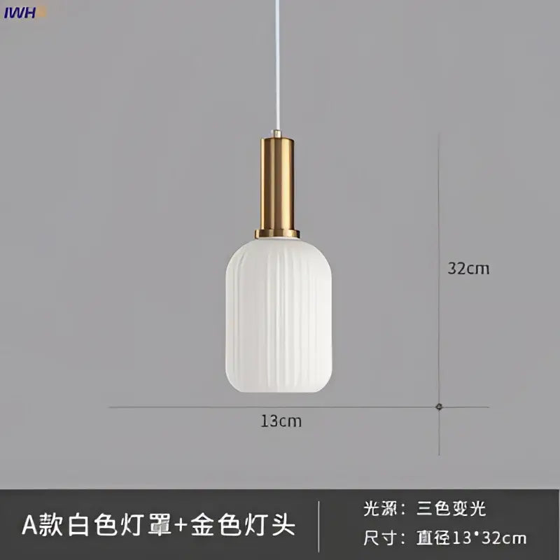 A sleek white ribbed glass pendant light with a brass stem and gold-toned metal fixture for dining room use