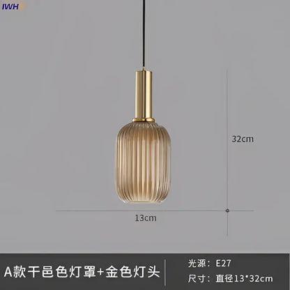 A sleek amber-tinted glass pendant light with vertical ridges and a brass stem for modern dining room lighting