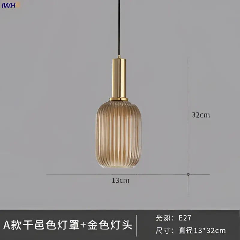 A sleek amber-tinted glass pendant light with vertical ridges and a brass stem for modern dining room lighting