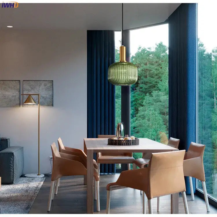 Modern pendant lights featuring green ribbed glass pendant with a gold-toned metal fixture for dining rooms