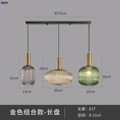 Set of three modern ribbed glass pendant lights in gray amber and green with brass stems for dining room use