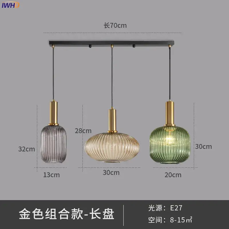 Set of three modern ribbed glass pendant lights in gray amber and green with brass stems for dining room use