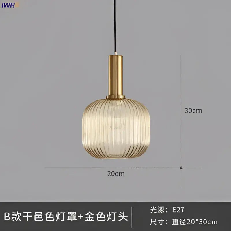 Modern ribbed glass pendant light with golden brass stem and translucent shade providing warm dining room illumination
