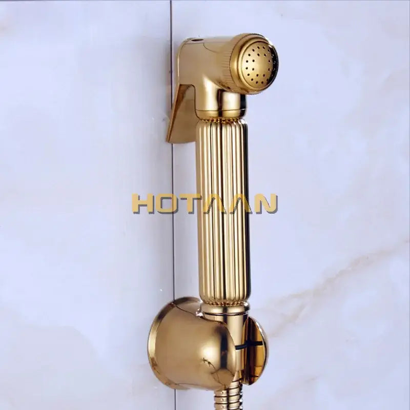 Modern ribbed gold brass bidet sprayer set with a gold-colored ribbed handheld shower nozzle and metallic finish