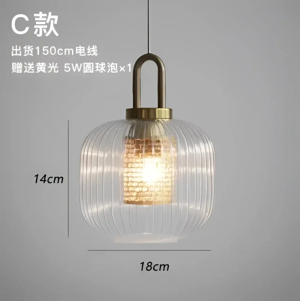 Modern ridged clear glass pendant lamp with brass top providing warm bedroom lighting by decorbites clear glass