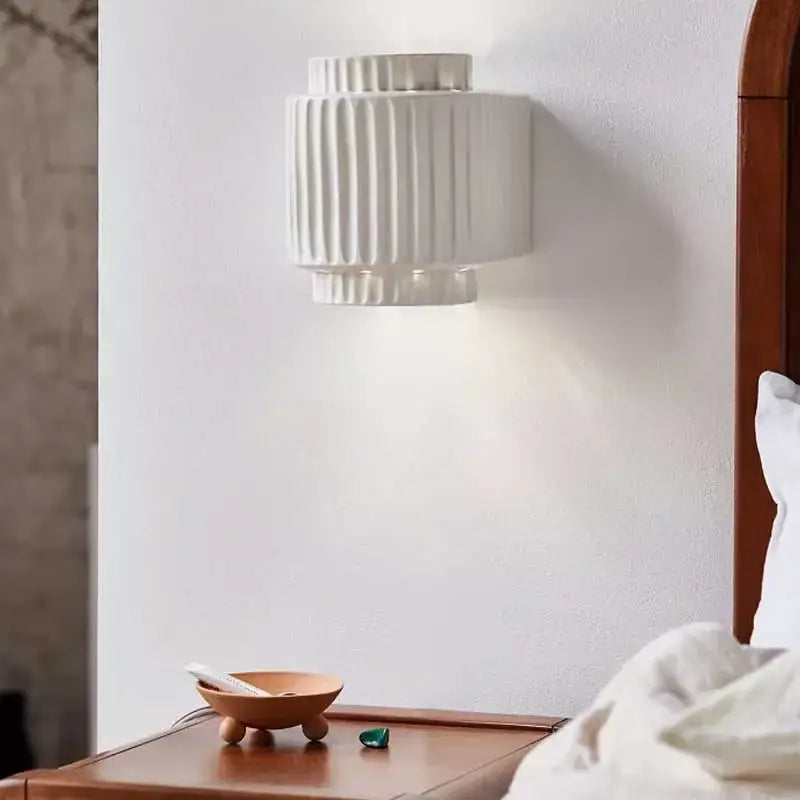 White ceramic wall lamp with vertical ridged texture in decorbites cream white resin for modern bedroom decor