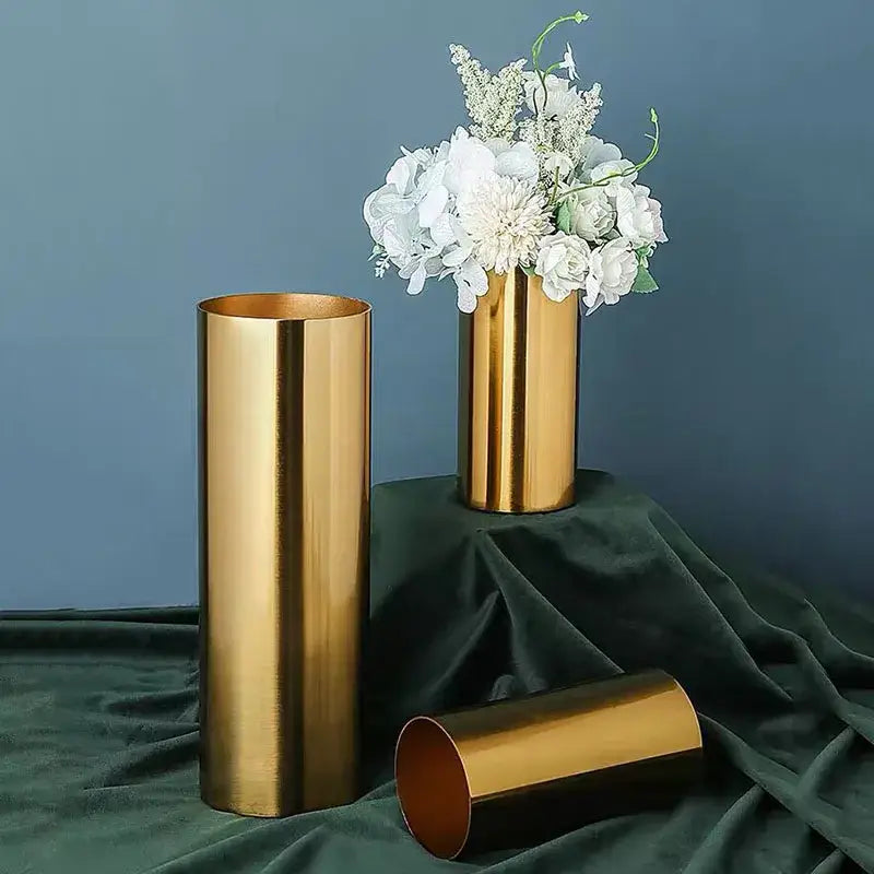 Modern ridged gold plated cylinder vase with sleek metallic finish holding white flowers for living room decorbites gold plated