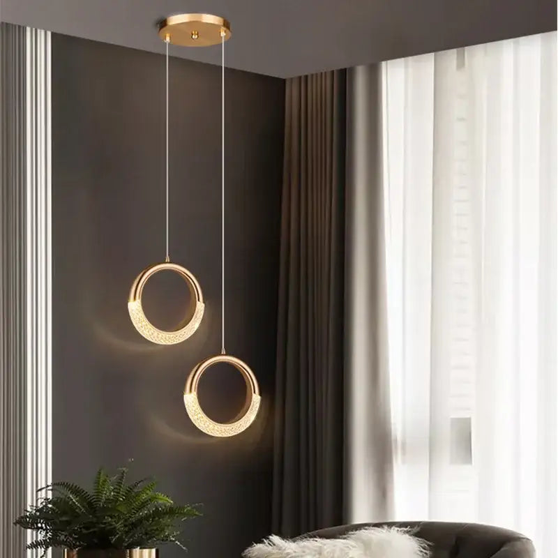 Modern rose gold acrylic led chandelier featuring gold-toned circular pendant lights with embedded led lighting