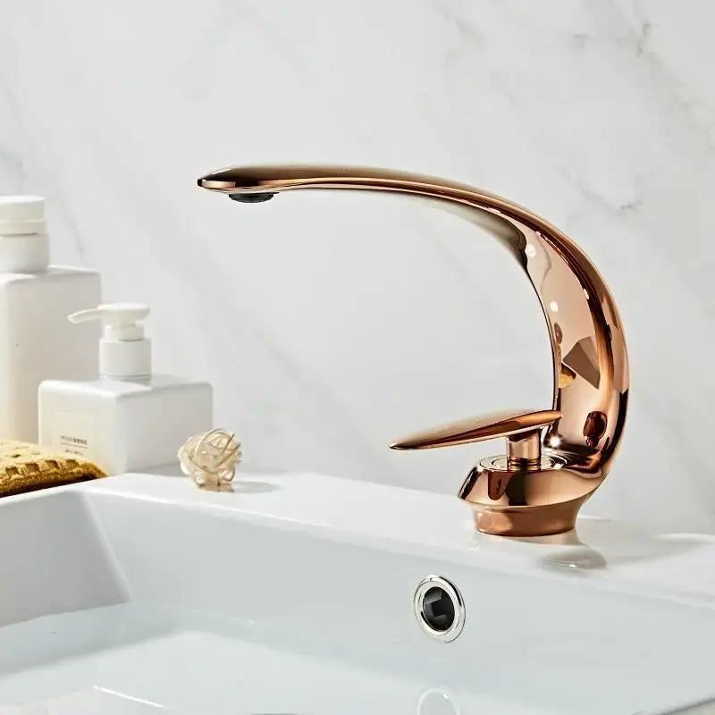 A decorbites basin faucet in rose gold finish with modern curved design and black brass mixer tap for bathroom use