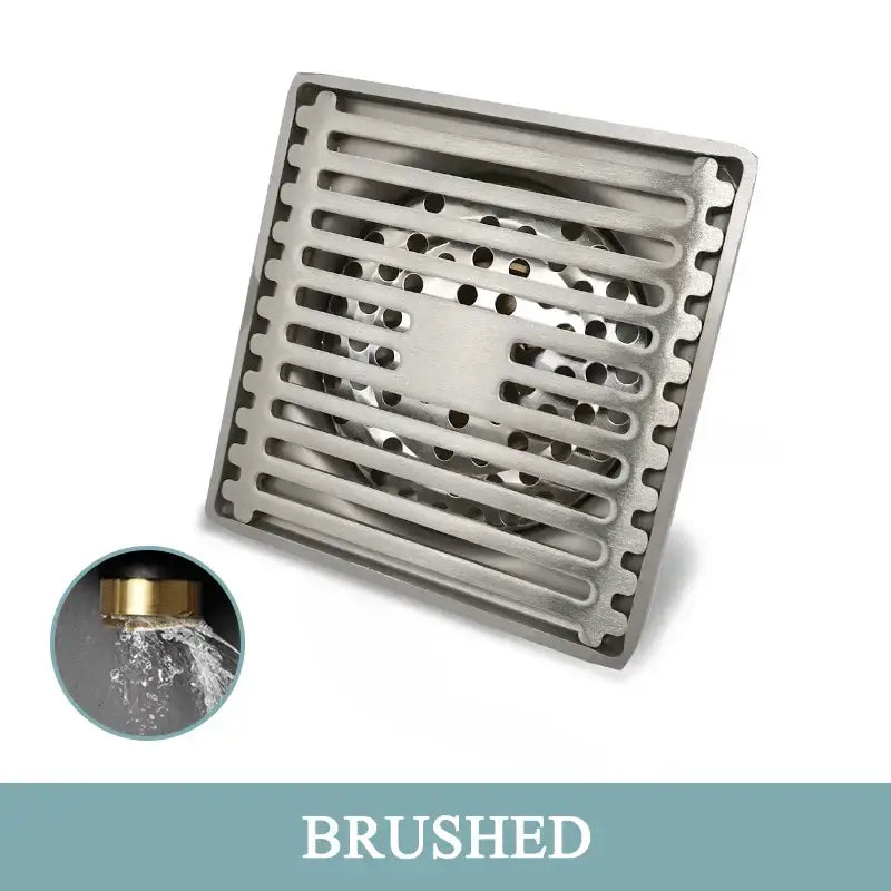 Modern rose gold brushed square floor drain with a stainless steel grid pattern and perforated center for bathroom use