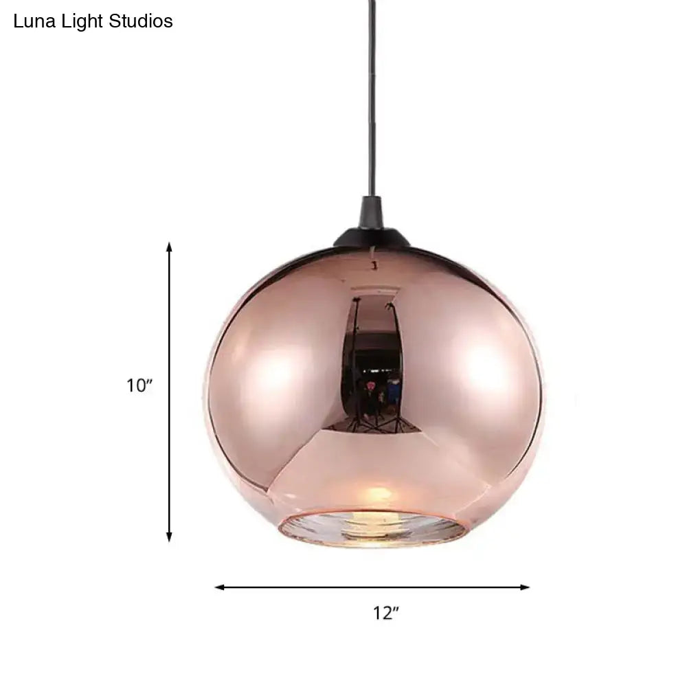 A sleek 10-inch tall modern rose gold copper sphere pendant light with a reflective glass globe and black cord
